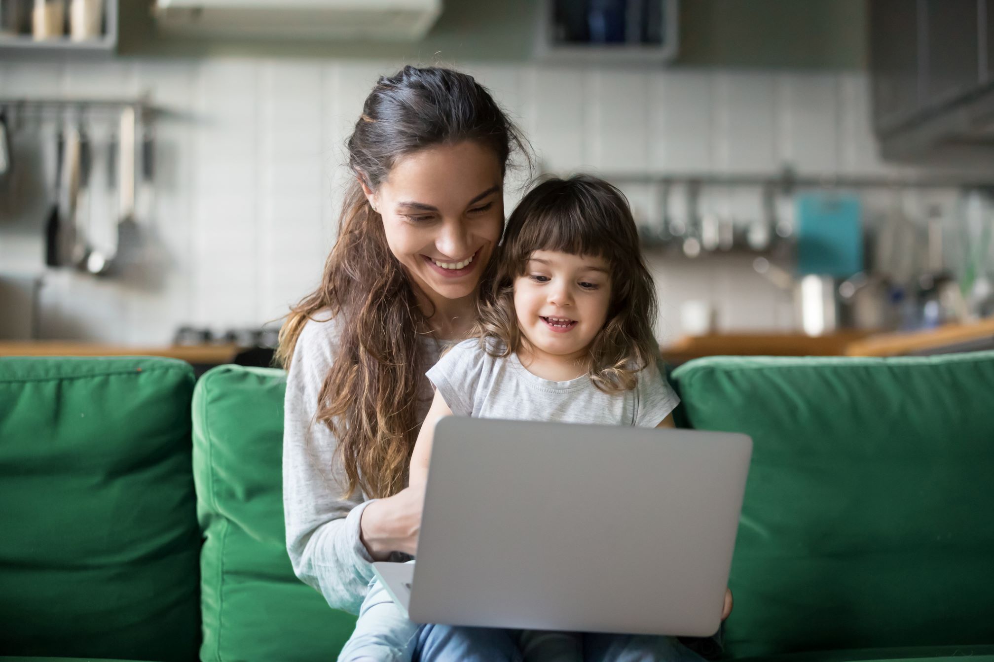 parents with her child looking at laptop